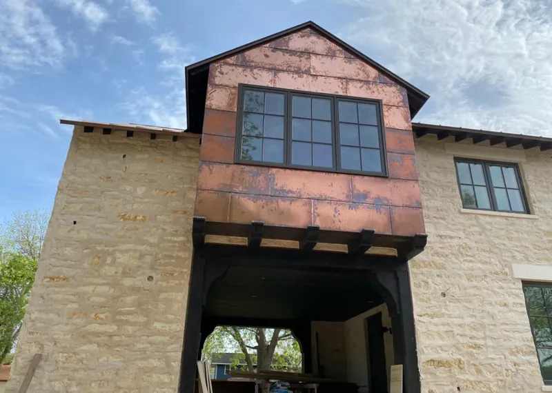 Copper metal panel facade on a stone building for Roof Repair in Pleasant Grove